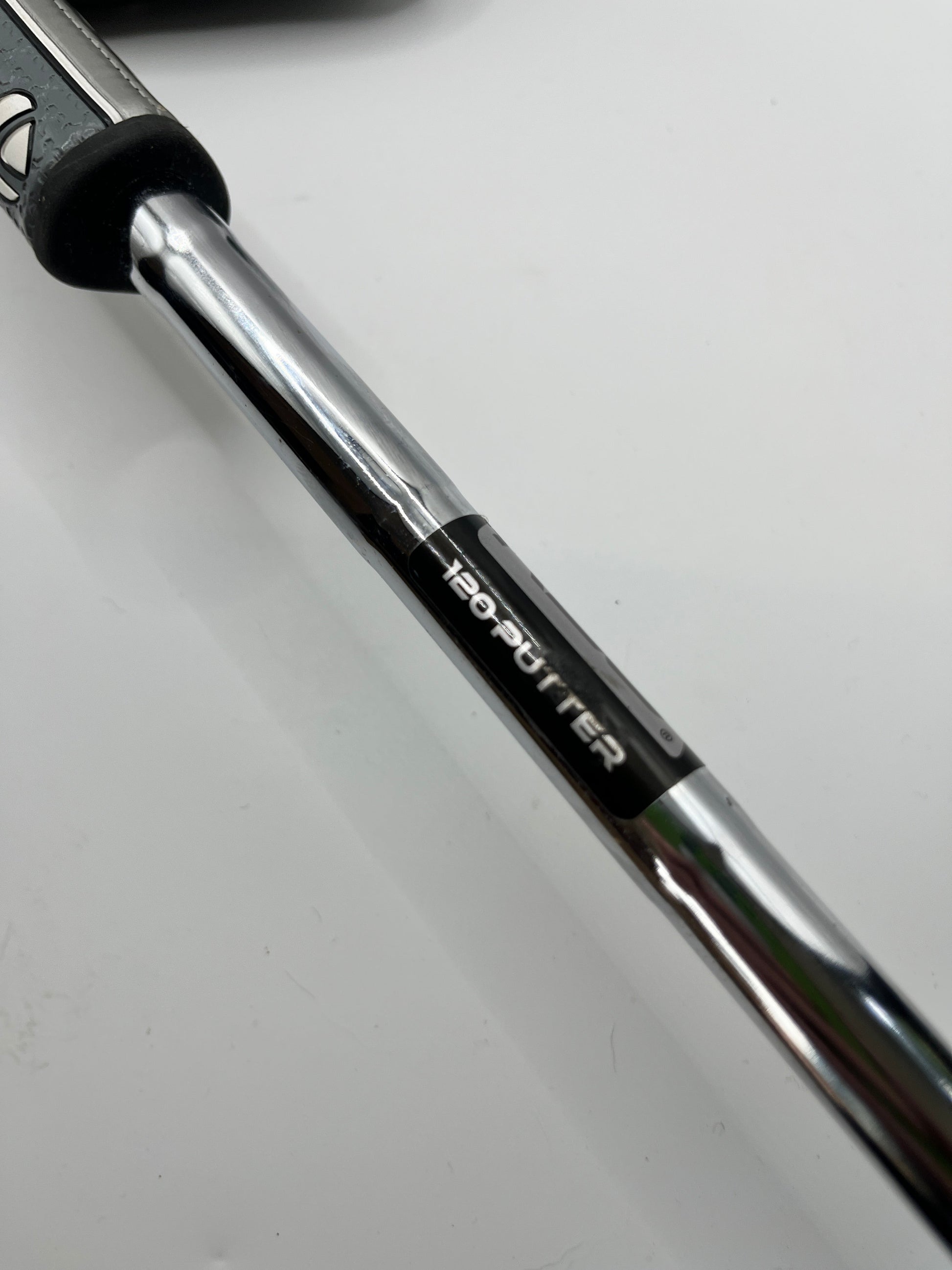 Close-up of a golf club shaft with '120-putter' branding on a white background
