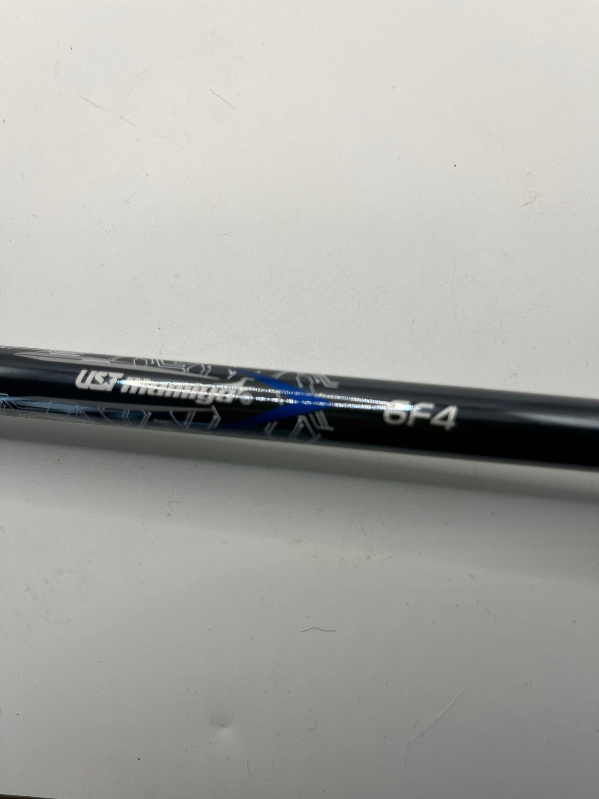 Golf club shaft with branding on a light gray background
